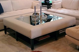 Custom upholstered Woodbine Ottoman tray table shown with a mirrored glass top, contemporary nailheads and a lower shelf for additional storage. 