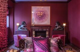Eclectic bedroom with a dramatic upholstered deep diamond tufted bed designed by Bespoke By Luigi Gentile. Interiors: Darrin Varden