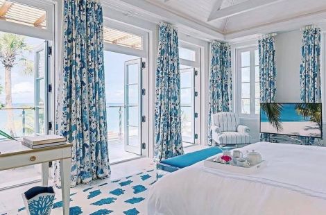 Custom upholstered bench with sleek Lucite legs and upholstered bed for this cerulean villa inspired room designed by Scott Salvator. Upholstery: Bespoke by Luigi Gentile