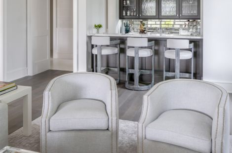 Compact and contemporary custom upholstered swivel club chairs with nail head trim for an elegant sitting room. \r\nInteriors: Robyn Karp Designs\r\nUpholstery: Bespoke by Luigi Gentile\r\nPhotography: Alex Kroke