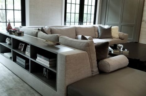 Large custom upholstered L shaped sectional with built in custom bookcase for additional storage. Interiors: Ginger Surasky Upholstery: Bespoke by Luigi Gentile