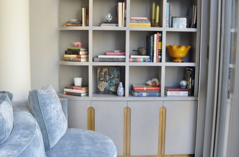 Custom made bookshelf with additional concealed storage making a perfect reading nook. Designer: Cary Jones. Upholstery and Casegoods: Bespoke by LG