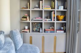 Custom made bookshelf with additional concealed storage making a perfect reading nook. Designer: Cary Jones. Upholstery and Casegoods: Bespoke by LG