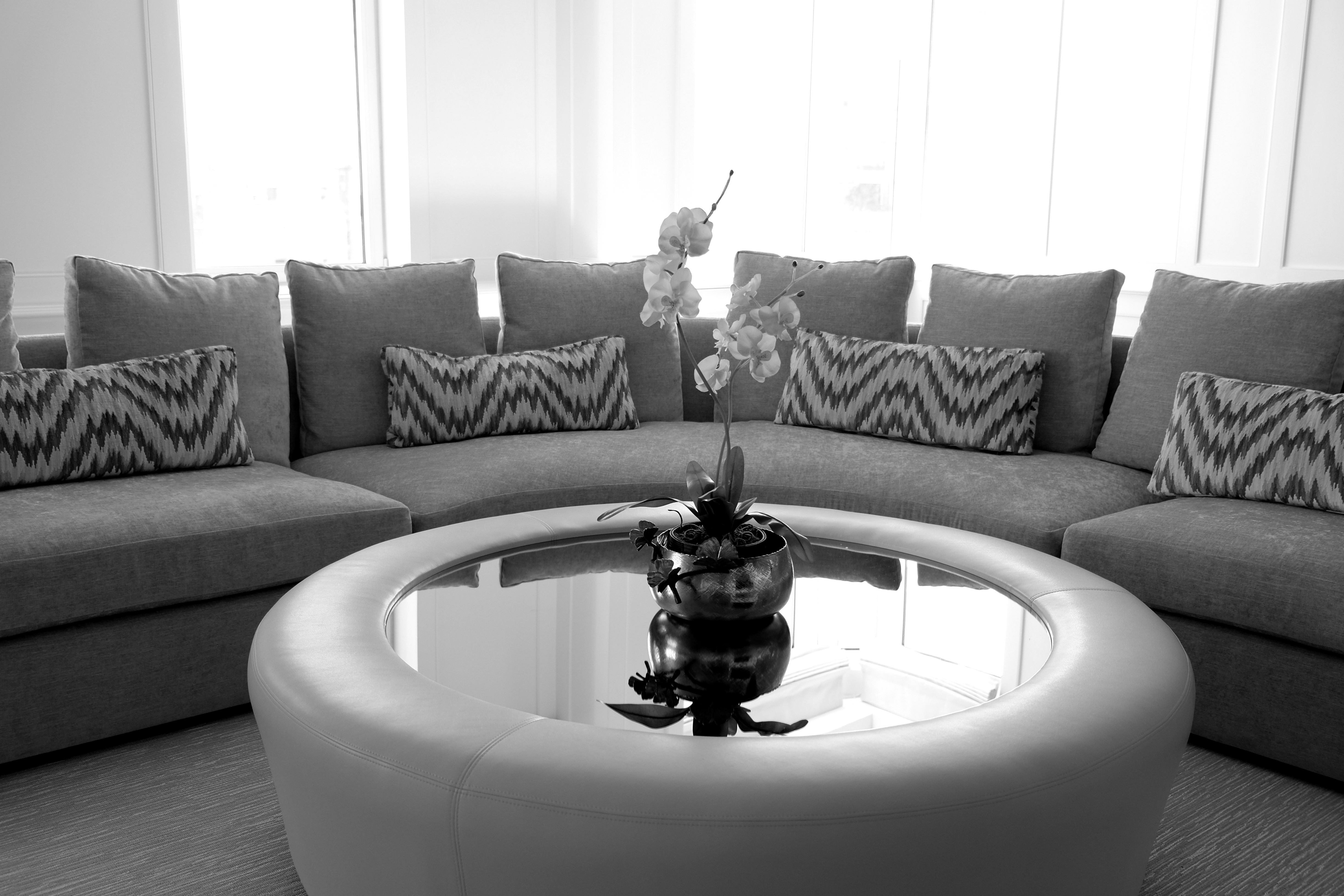 Custom upholstered sofa and ottoman with glass top by Bespoke by Luigi Gentile