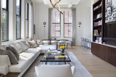Elegant custom left arm facing L shaped sectional with wooden drink table and blackened steel metal coffee table with glass top.