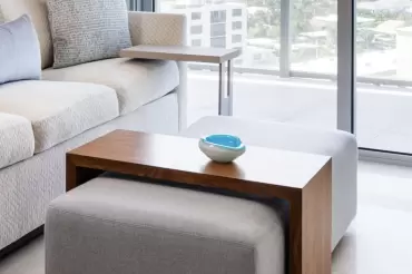 The Barrow Bridge ottoman table features a gliding table, upholstered cushion base, multifunctional design, and contemporary elegance 