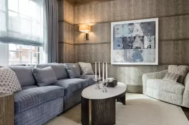 Featuring wood arms and soft cushions, this sofa is complemented by a soft and comfortable corner chair