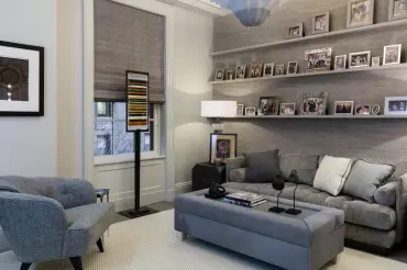 The bespoke sofa and ottoman feature tailored grey upholstery, plush cushions, and multifunctional design, blending comfort with understated