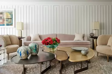 This camelback sofa features graceful curves, tailored cushions, and elegance, blending classic form with modern sophistication