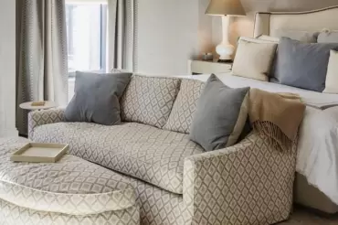 The Catherine sofa and ottoman feature tailored upholstery, clean lines, plush cushions, and versatile comfort, perfect for any room