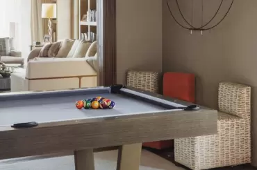Small and rearrangeable multi-colored chairs are a perfet addition to this amazing game room. 