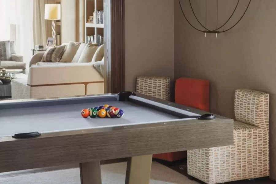 Small and rearrangeable multi-colored chairs are a perfet addition to this amazing game room. 