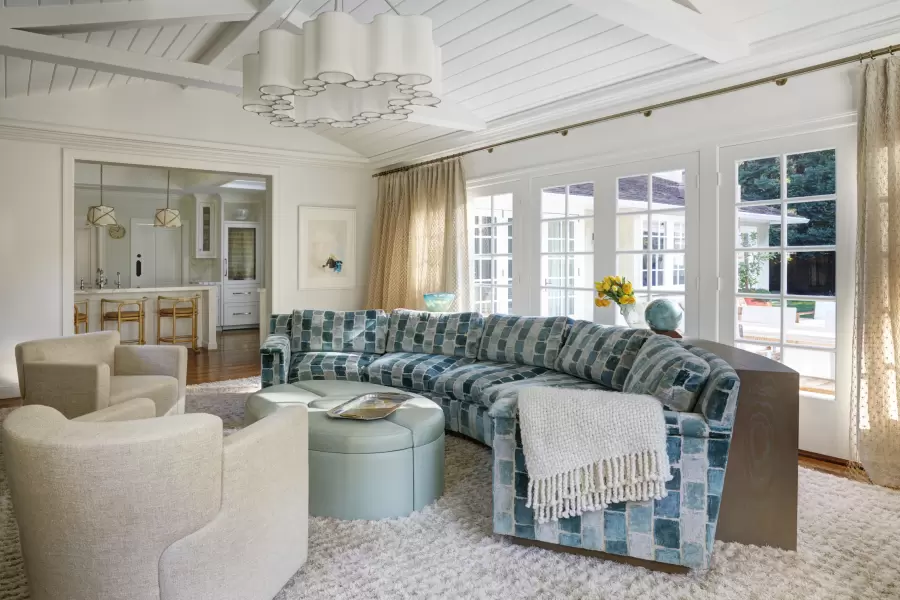 A custom Whitehall curved sofa is in bright light with our oak custom built bookcase in the rear to follow the curve. Impressive design creativity by Penny Drue Baird.