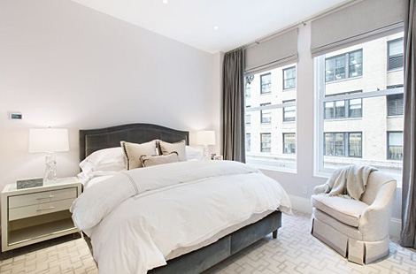 Contemporary styled queen size soft sloping headboard with light tufting in dark grey velvet. Matching white and lucite night stands and custom swivel chair with skirted base. Interiors by  G. Sitomer Design, Custom bed Bespoke by Luigi Gentile. 