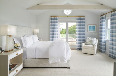 Side view of a stunning king size button-less box tufted upholstered bed with matching plain upholstered box spring for designer, Robyn Karp Designs.  