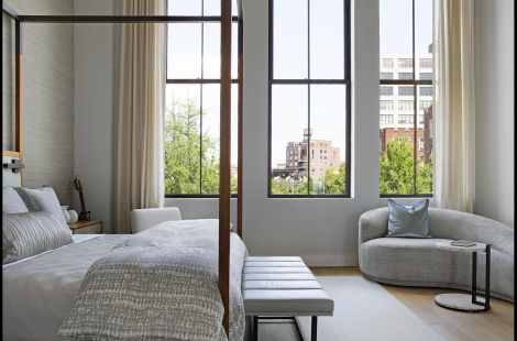 Fabulous custom king poster bed with an modern upholstered headboard adorned with attached overhead reading lights paired with a channeled upholstered bench with a blackened steel metal base by Bespoke by Luigi Gentile. Interiors: Rona Landman